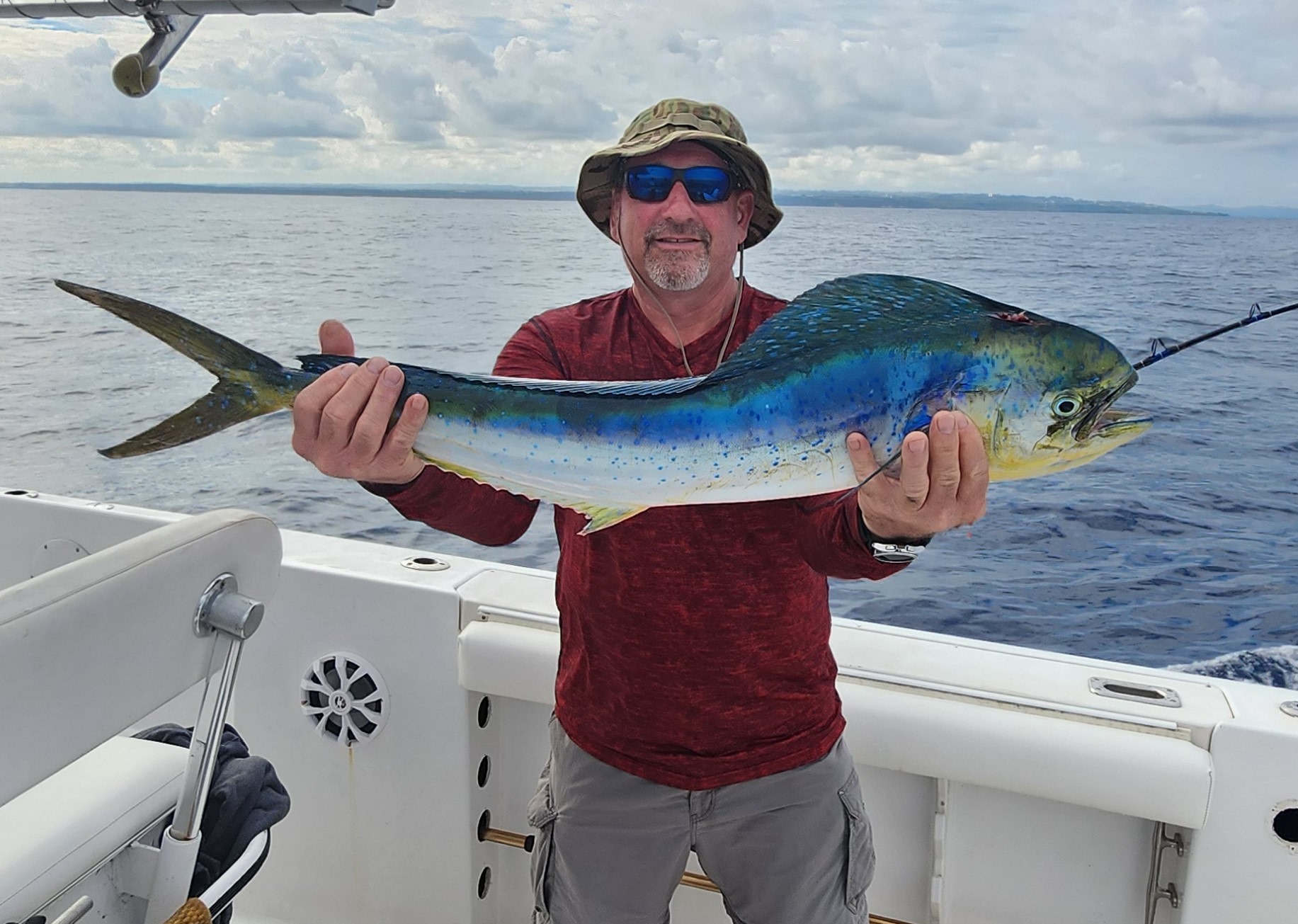 Jeff Workman - Co-Founder proudly displaying a beautiful mahi-mahi catch on his fishing boat in Southwest Florida waters
